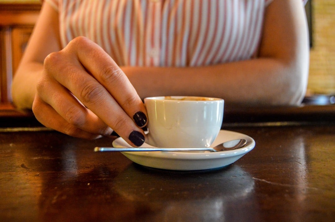 person holding espresso cup