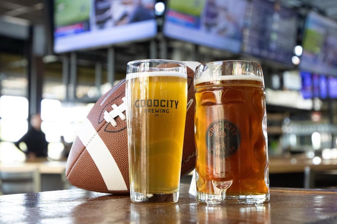 Good City Brewing beers with a football in the background