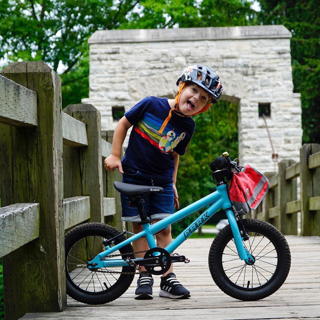 Young kid on Hoyt Park bridge with blue bike